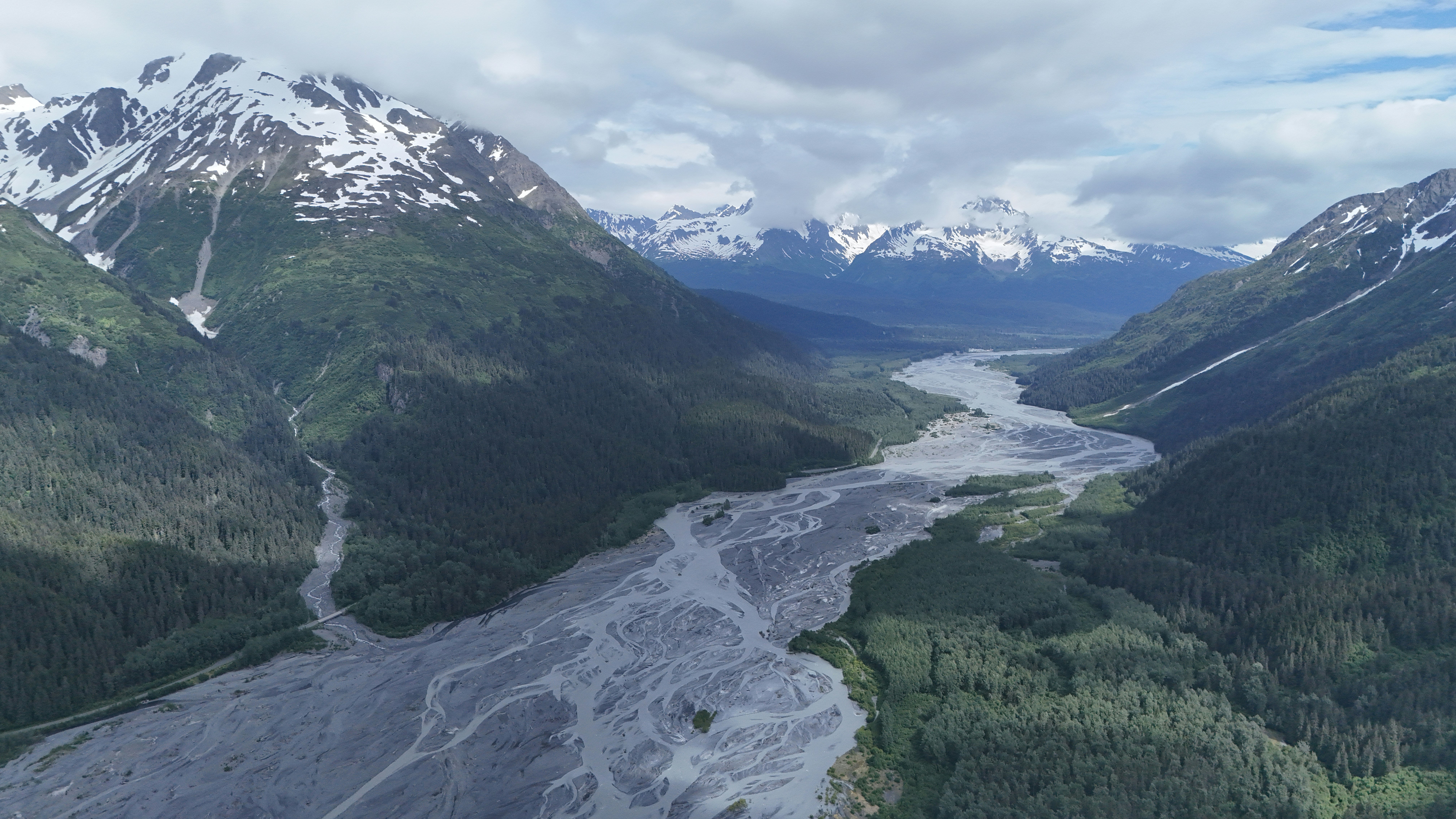 A wide river flows through a mountain valley.