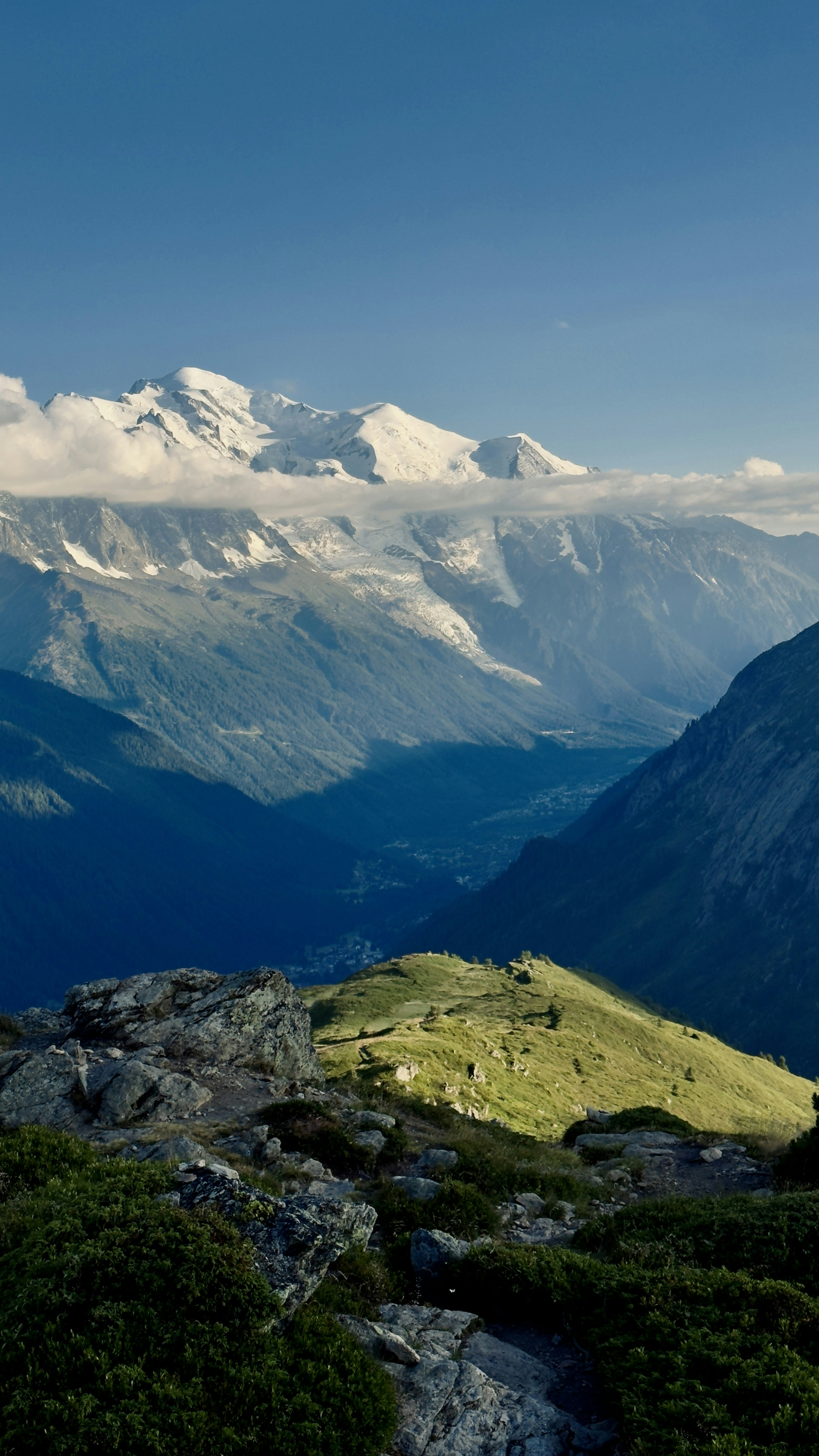 Snow-capped mountains rise above a scenic valley.