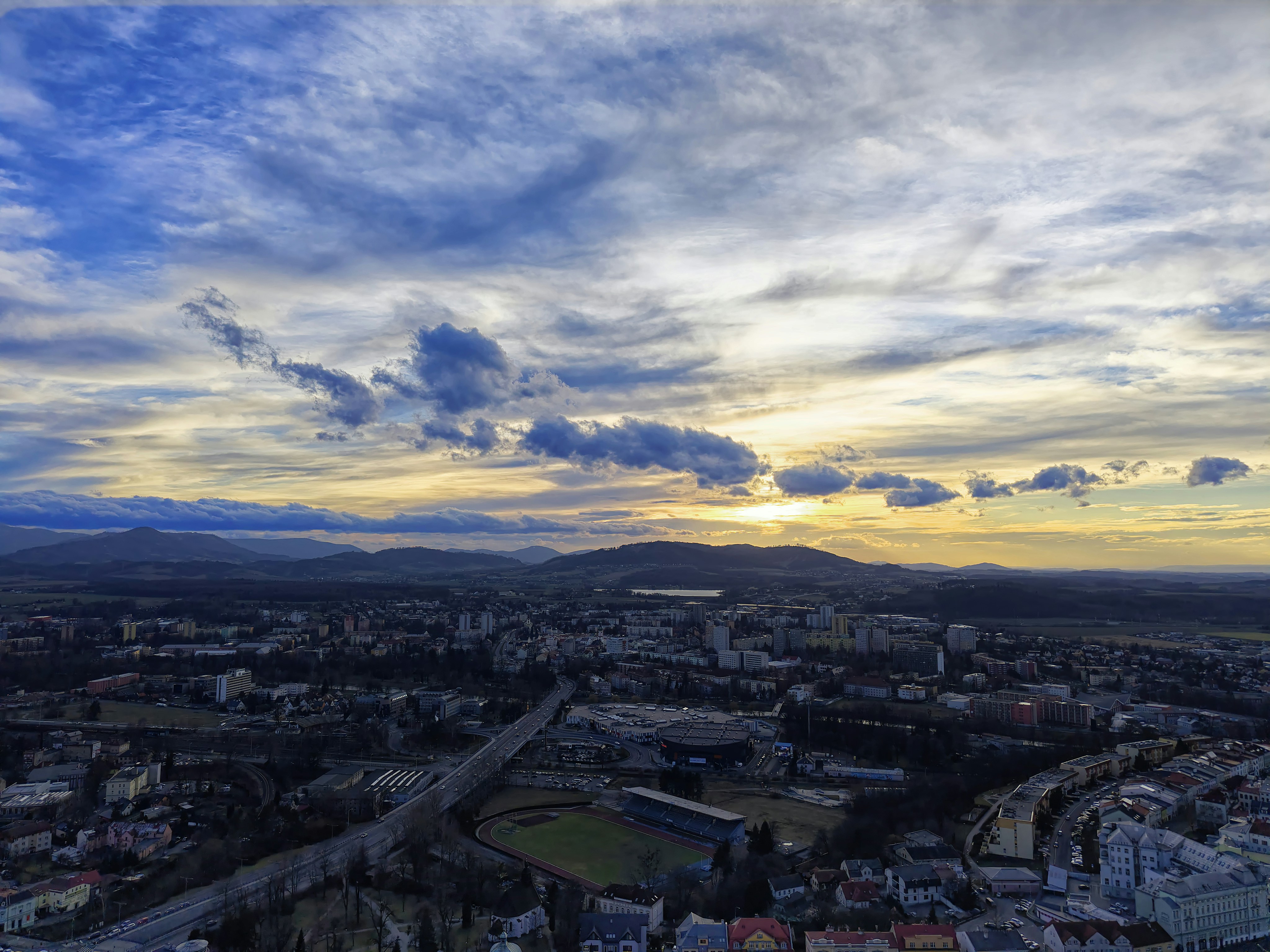 Cityscape under a dramatic, cloudy sky.