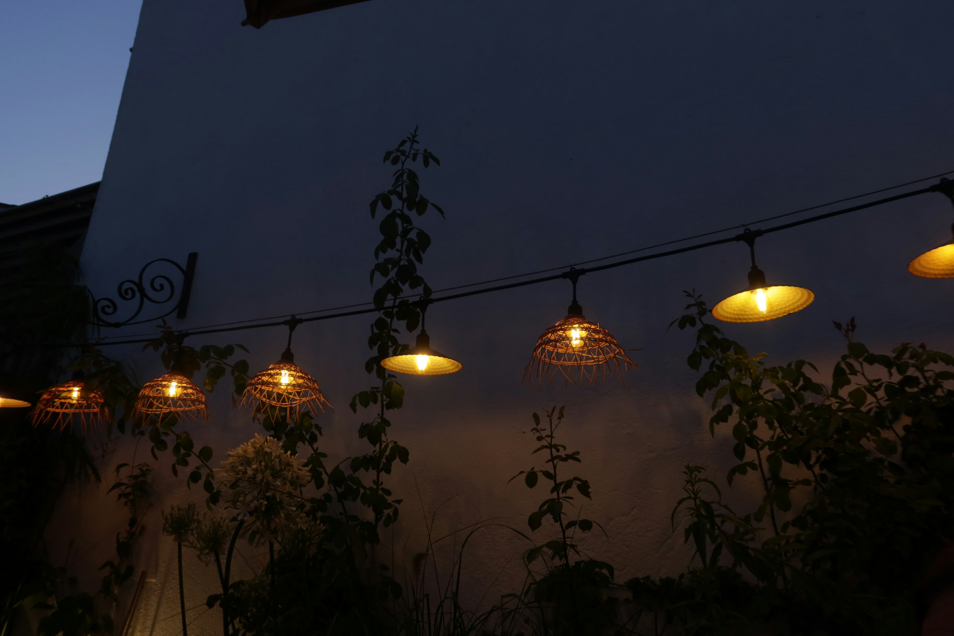 Outdoor string lights illuminate the night sky.