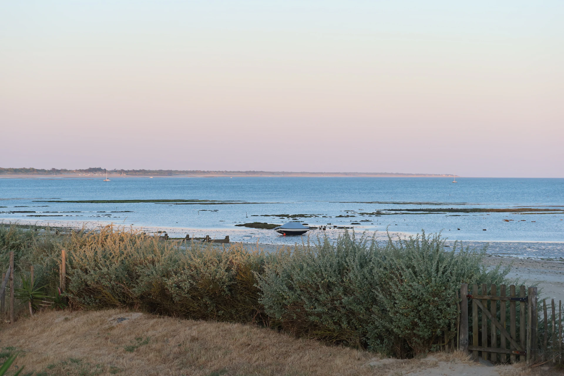 Dusk at the beach with the water calm.