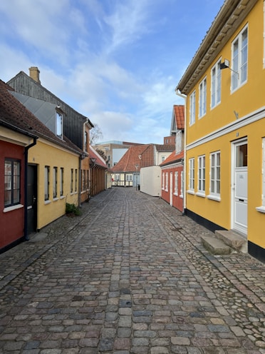 A cobblestone street with colorful buildings.