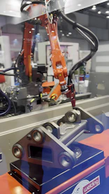 A robotic arm welds a metal part.