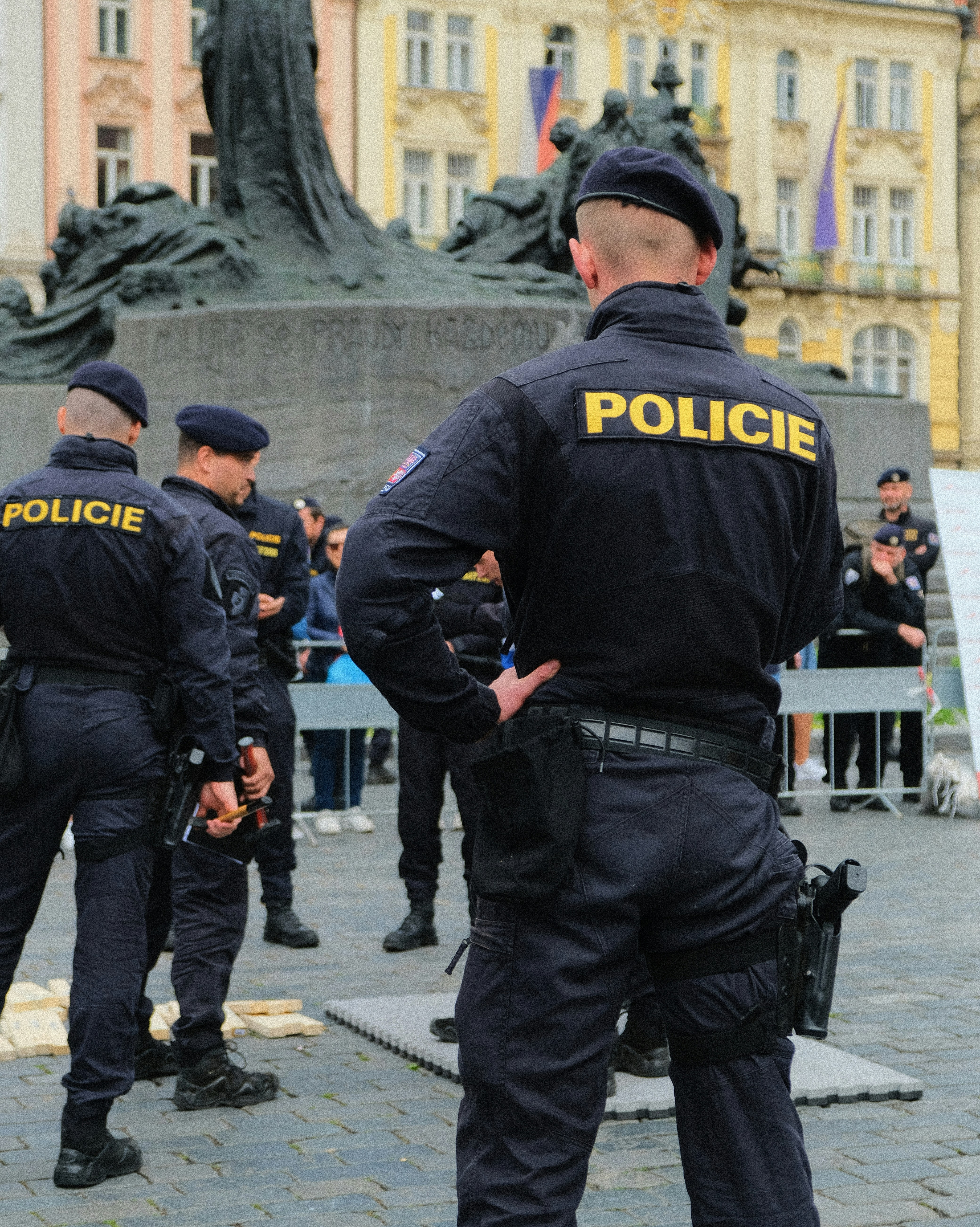 Police officers are seen standing guard in a public space.