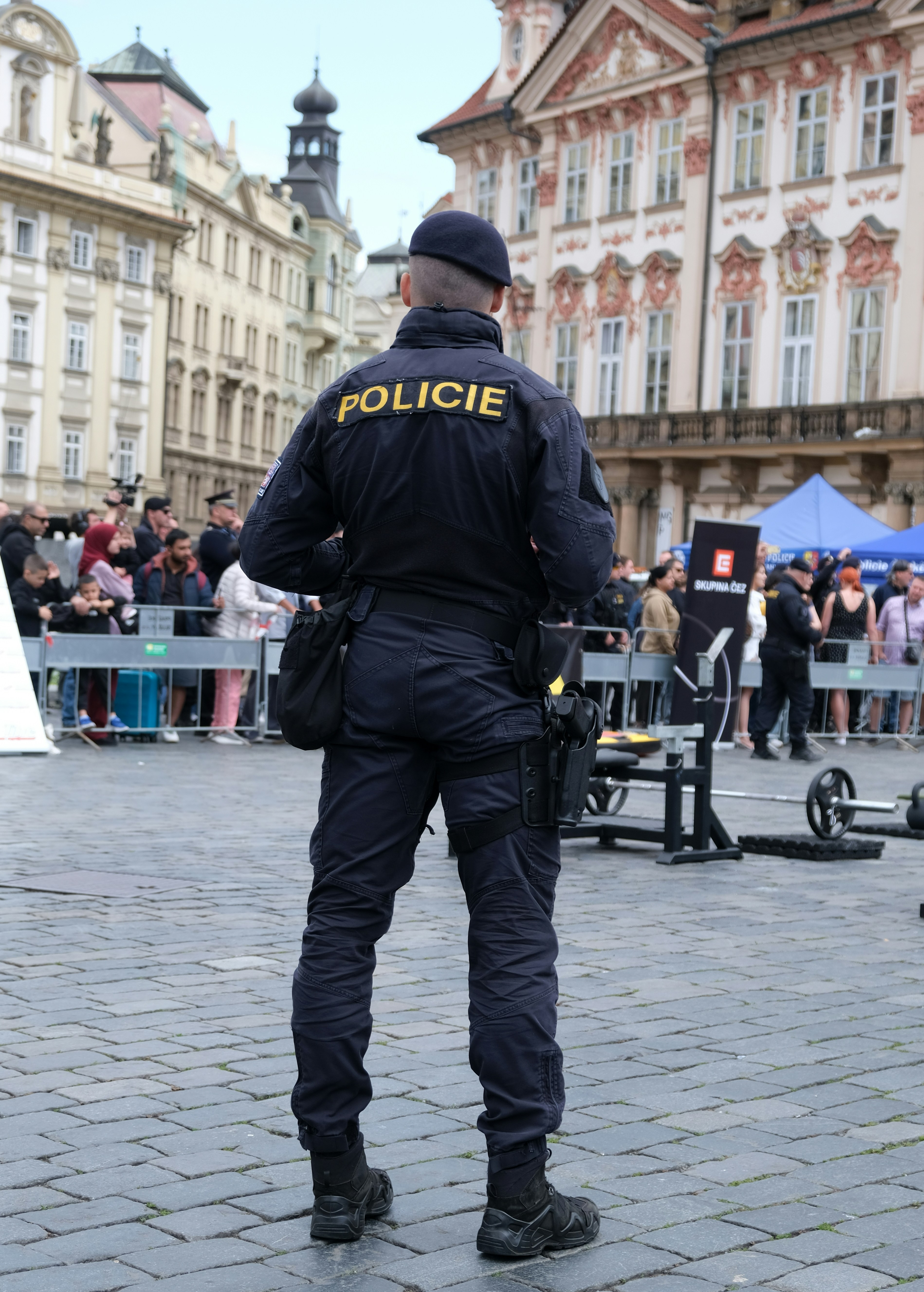 A policeman stands watch over the crowd.