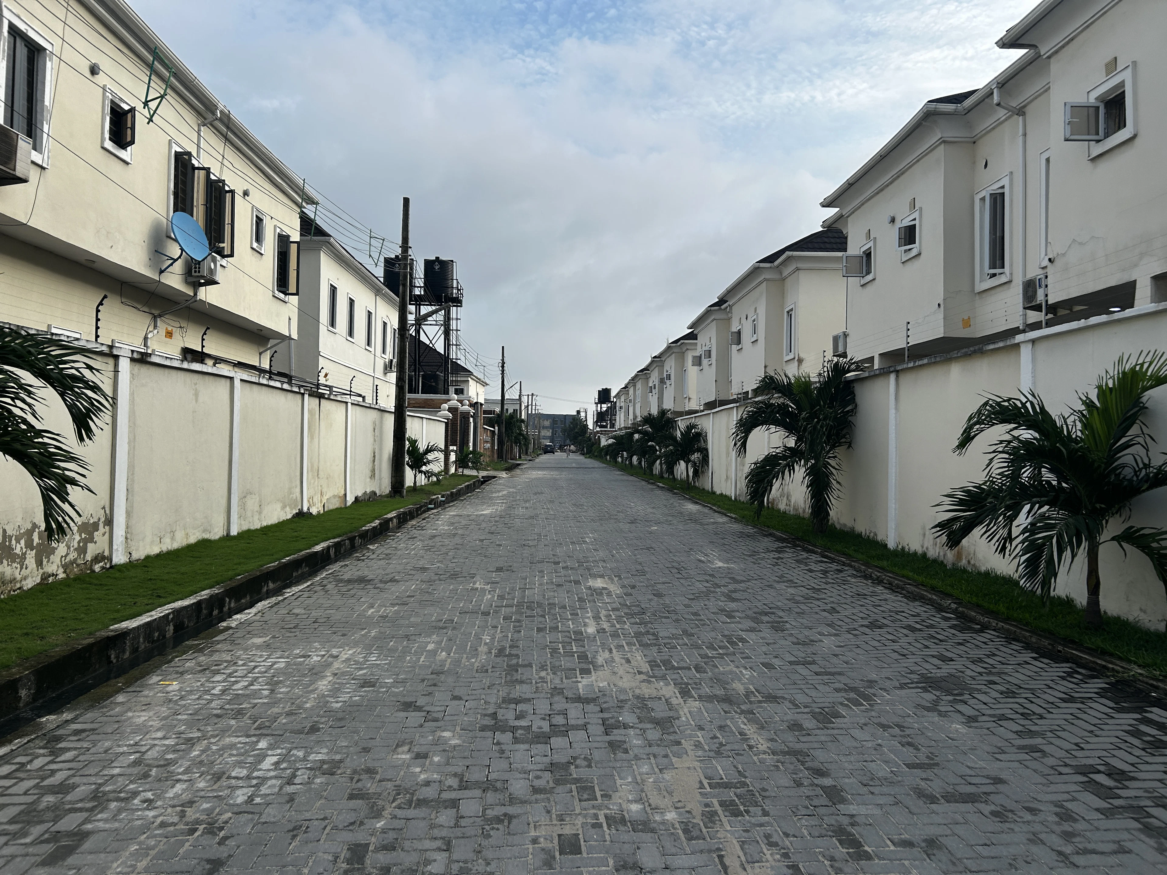Street of new houses behind low walls