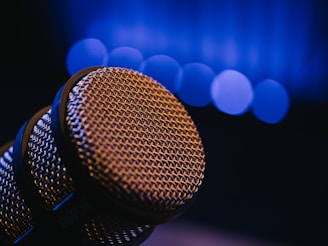 Close-up of a microphone with blurred blue lights.