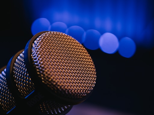 Close-up of a microphone with blurred blue lights.