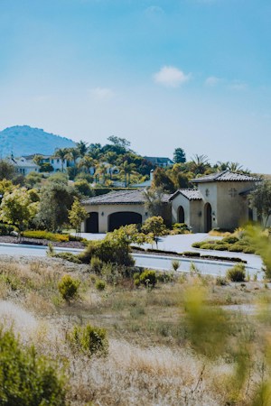 A large luxury home sitting in a sunny landscape, similar in scale to high end houses in Seven Hills, Henderson