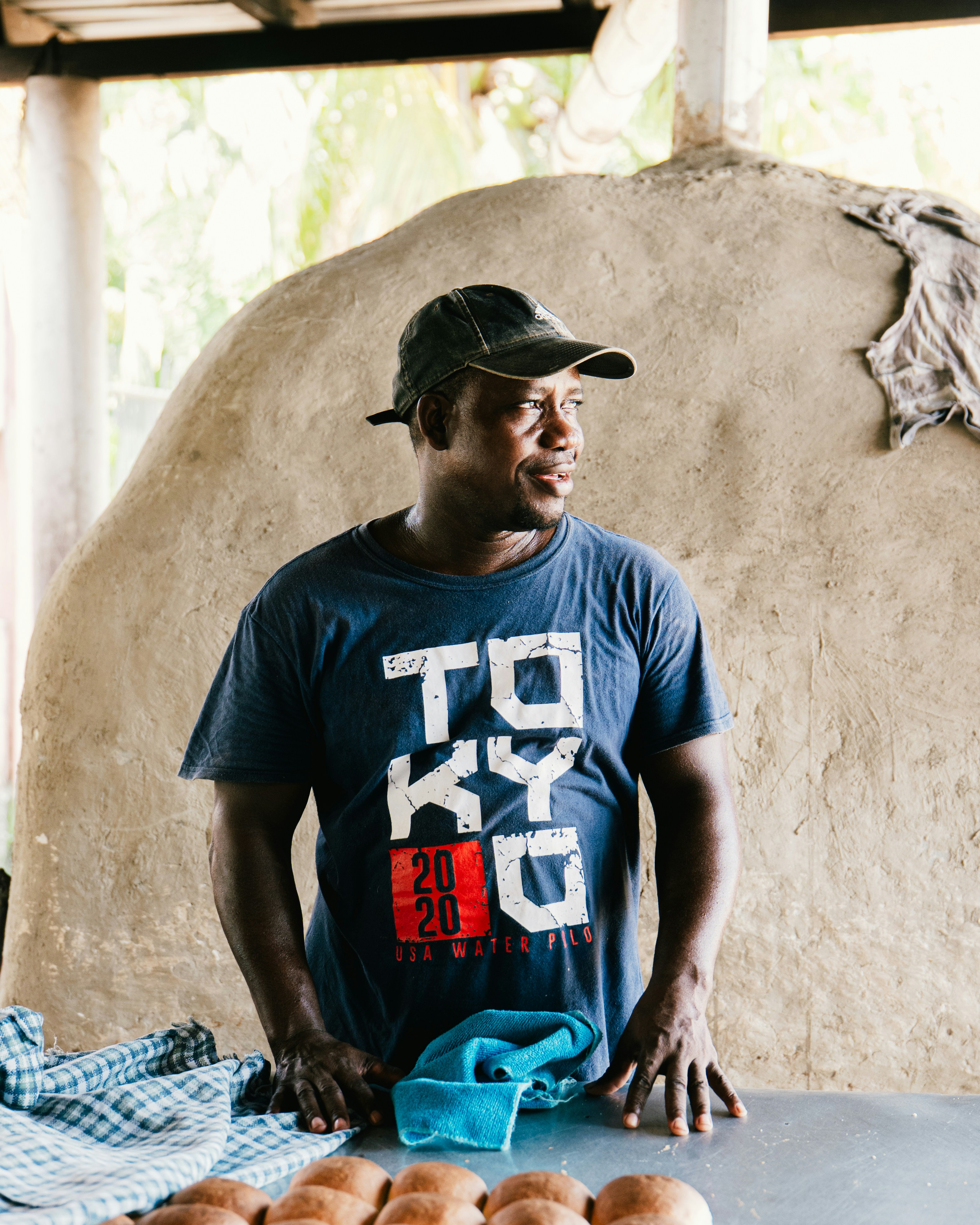 A man stands by an oven, possibly a baker.