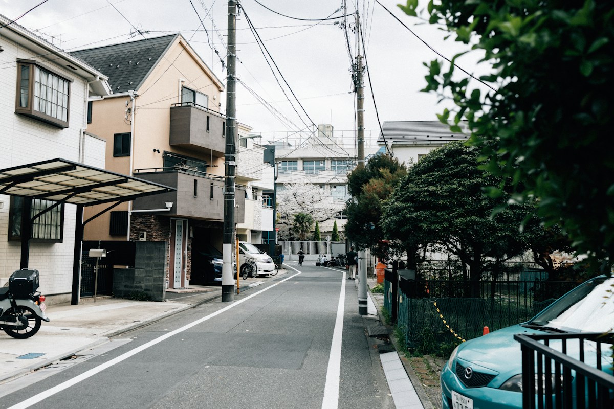 A quiet residential street in Tokyo, calm and empty in the afternoon light
