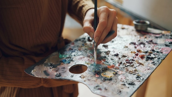 An artist paints using a colorful palette.
