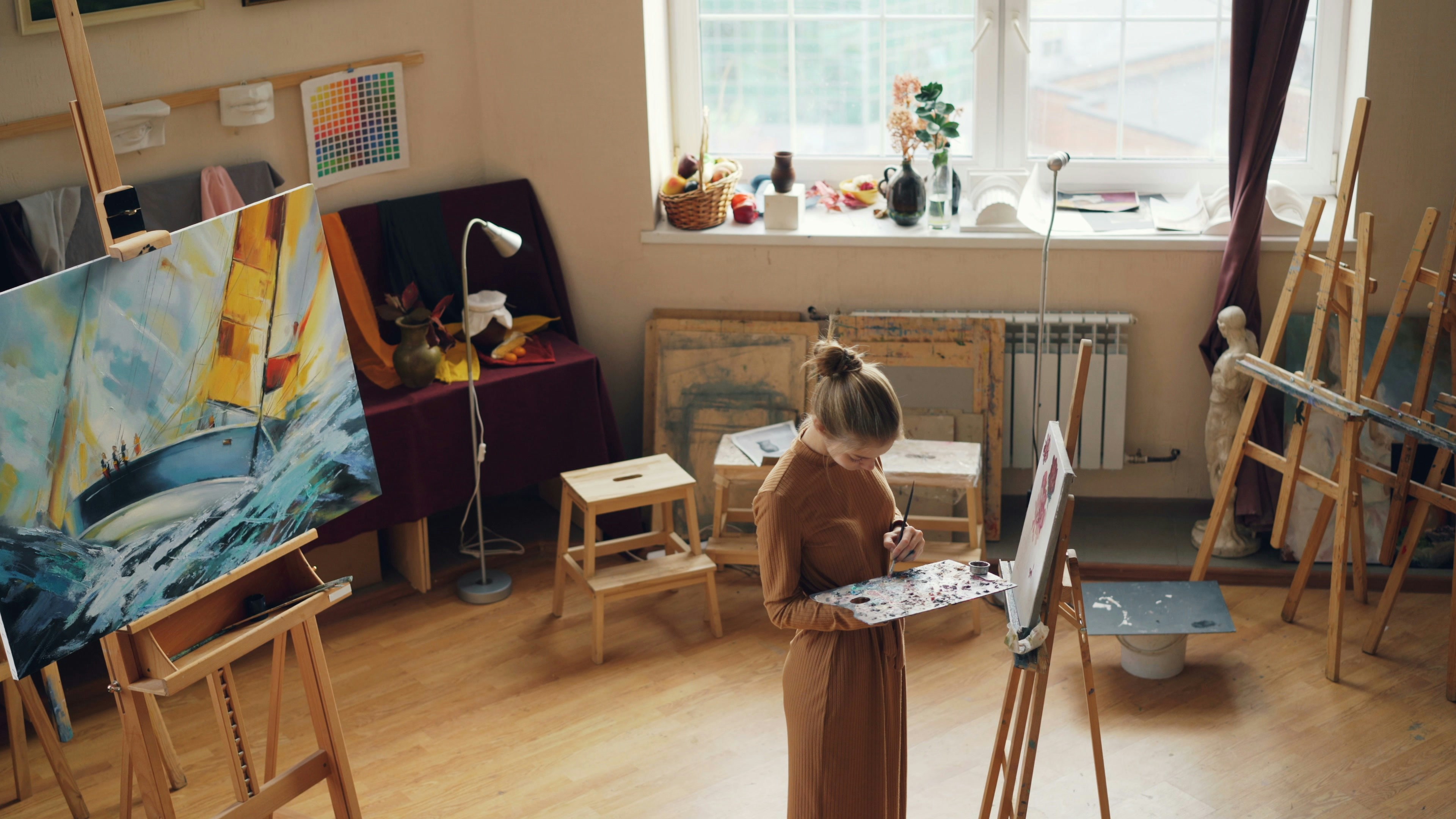 Half-cleaned artist studio with tea and brushes — visual metaphor for artful living and quiet control.