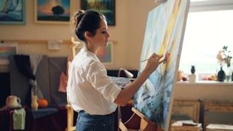 A woman paints a picture in her art studio.