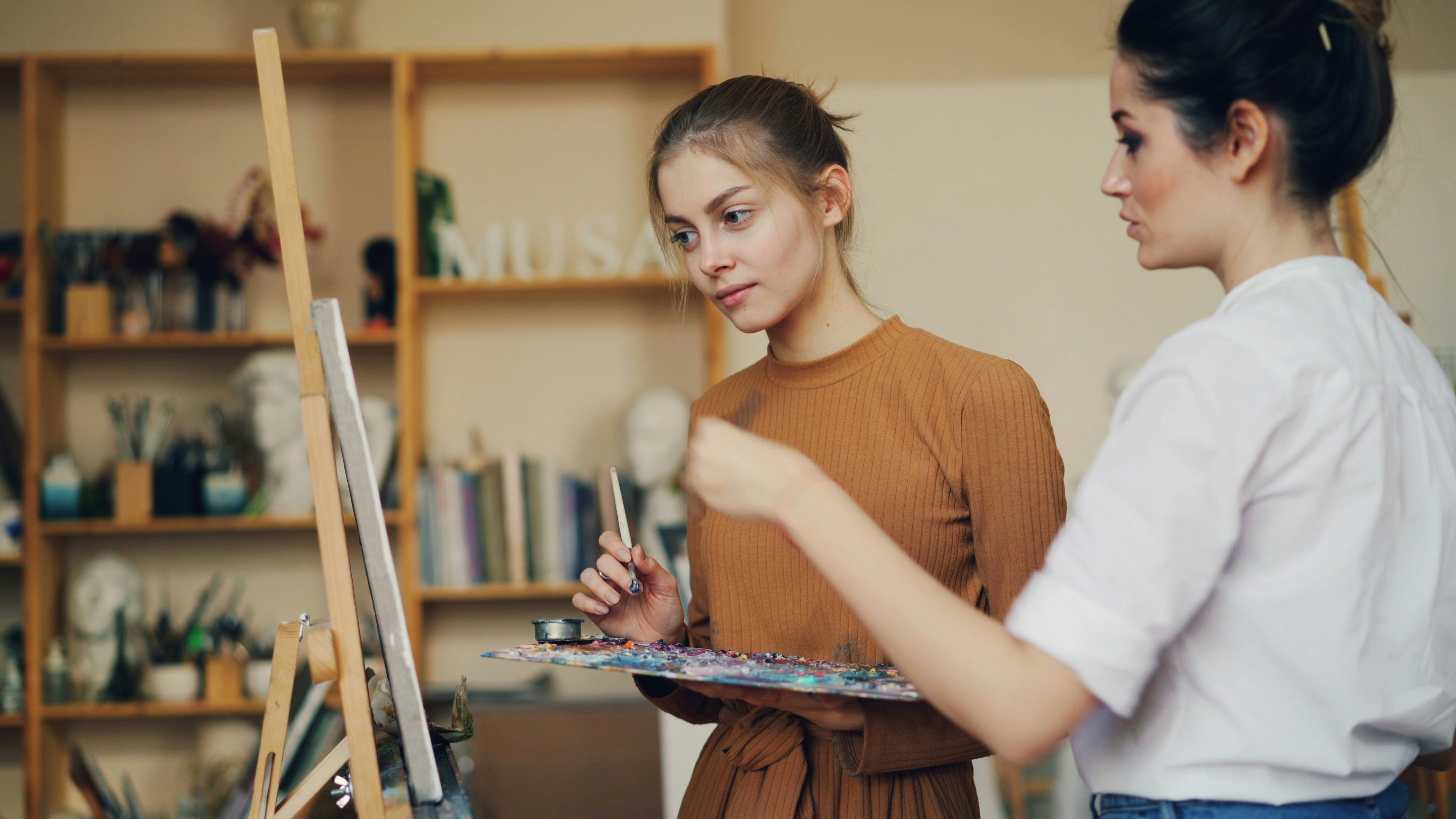 Teacher explaining painting techniques