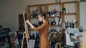 A woman paints in her artistic studio.