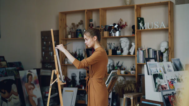 A woman paints in her artistic studio.
