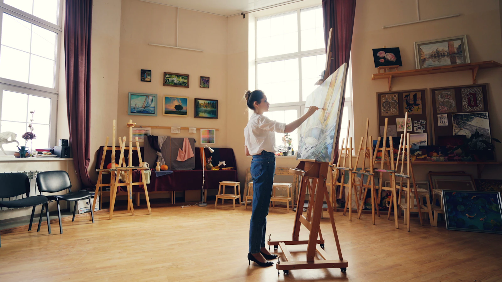 Artist working on a painting in a studio