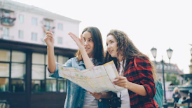 Two women use a map to find directions.