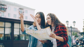 Two women use a map to find directions.