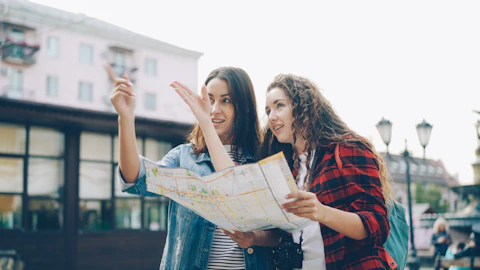 Two women use a map to find directions.
