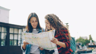 Two women are looking at a map together.