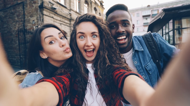 Three friends taking a selfie outdoors