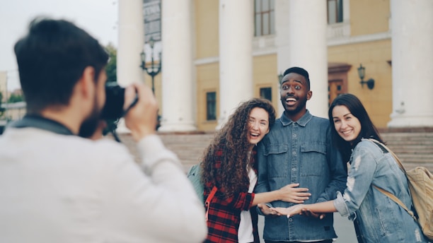 A photographer takes a picture of happy friends.