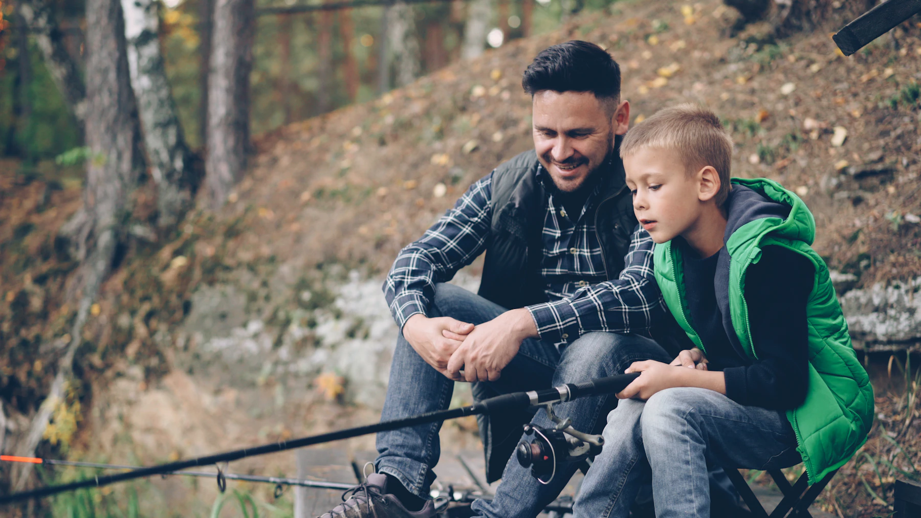 Father teaching his son to fish