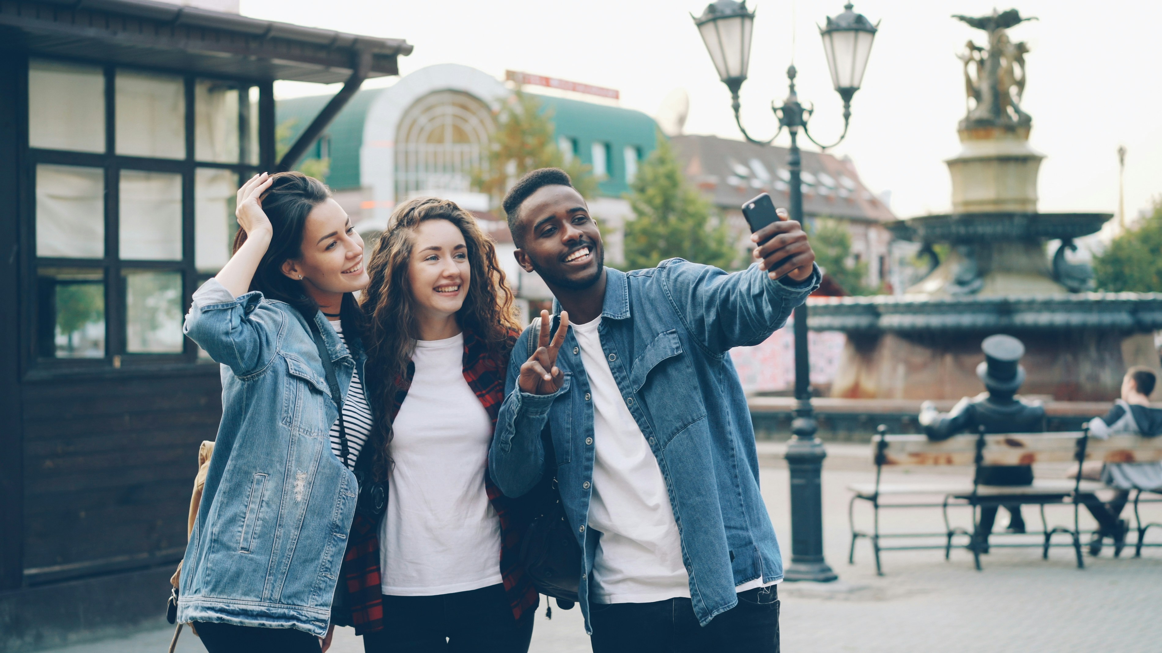 Diverse group of young people engaging with content on their smartphones - global media industry analysis