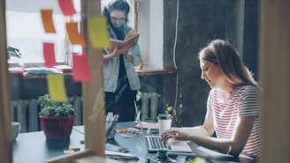 Two people work together in a modern office.