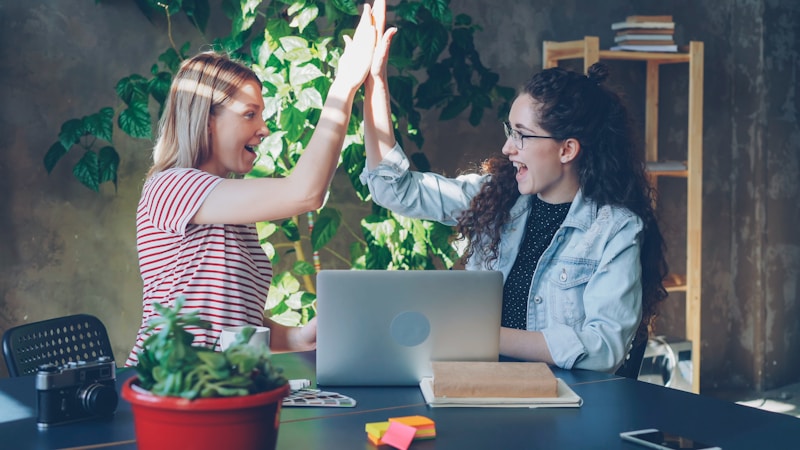 women celebrating partnership success