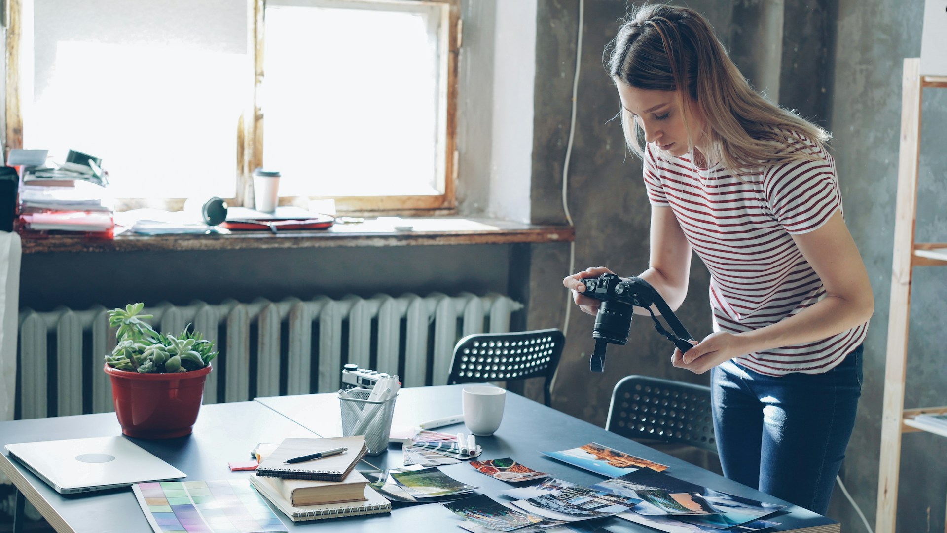 A woman is taking pictures in her home.