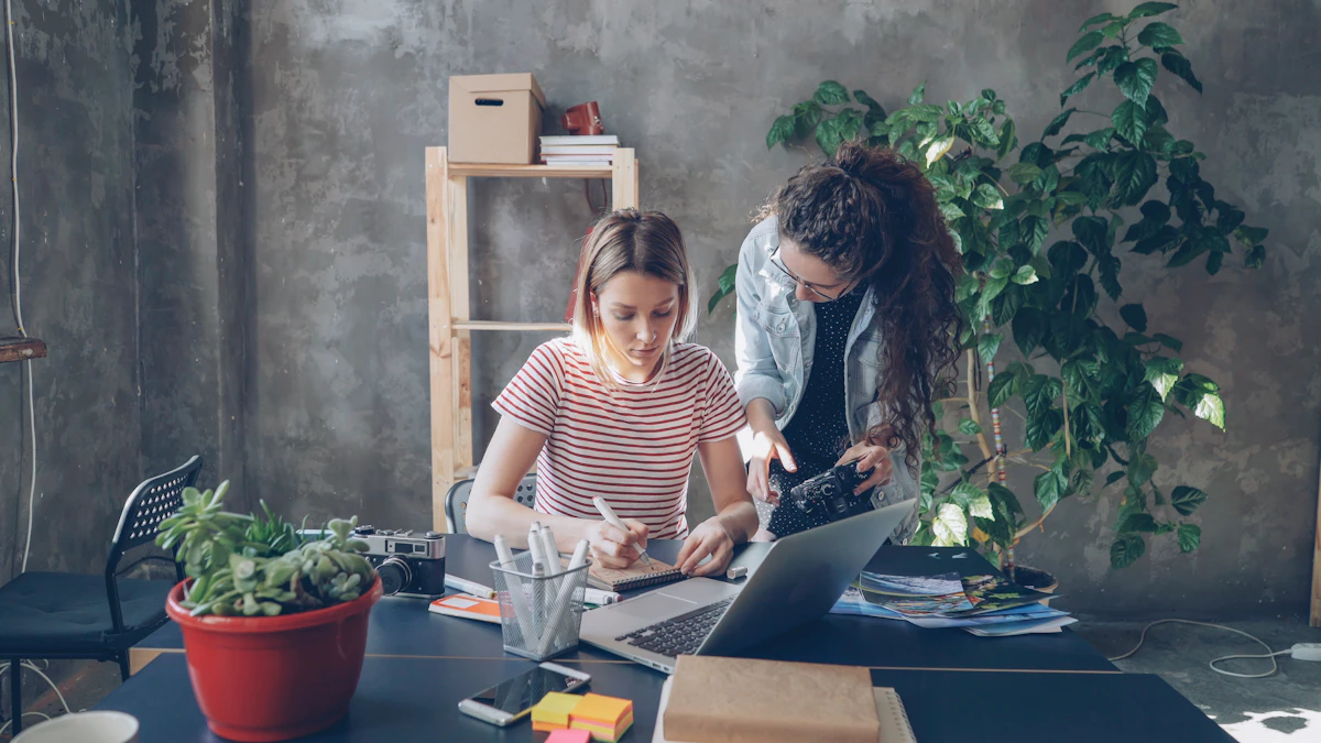 Two women collaborate at a desk.