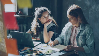 Two women are working together on a project.