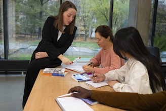 A woman is guiding people in a meeting.