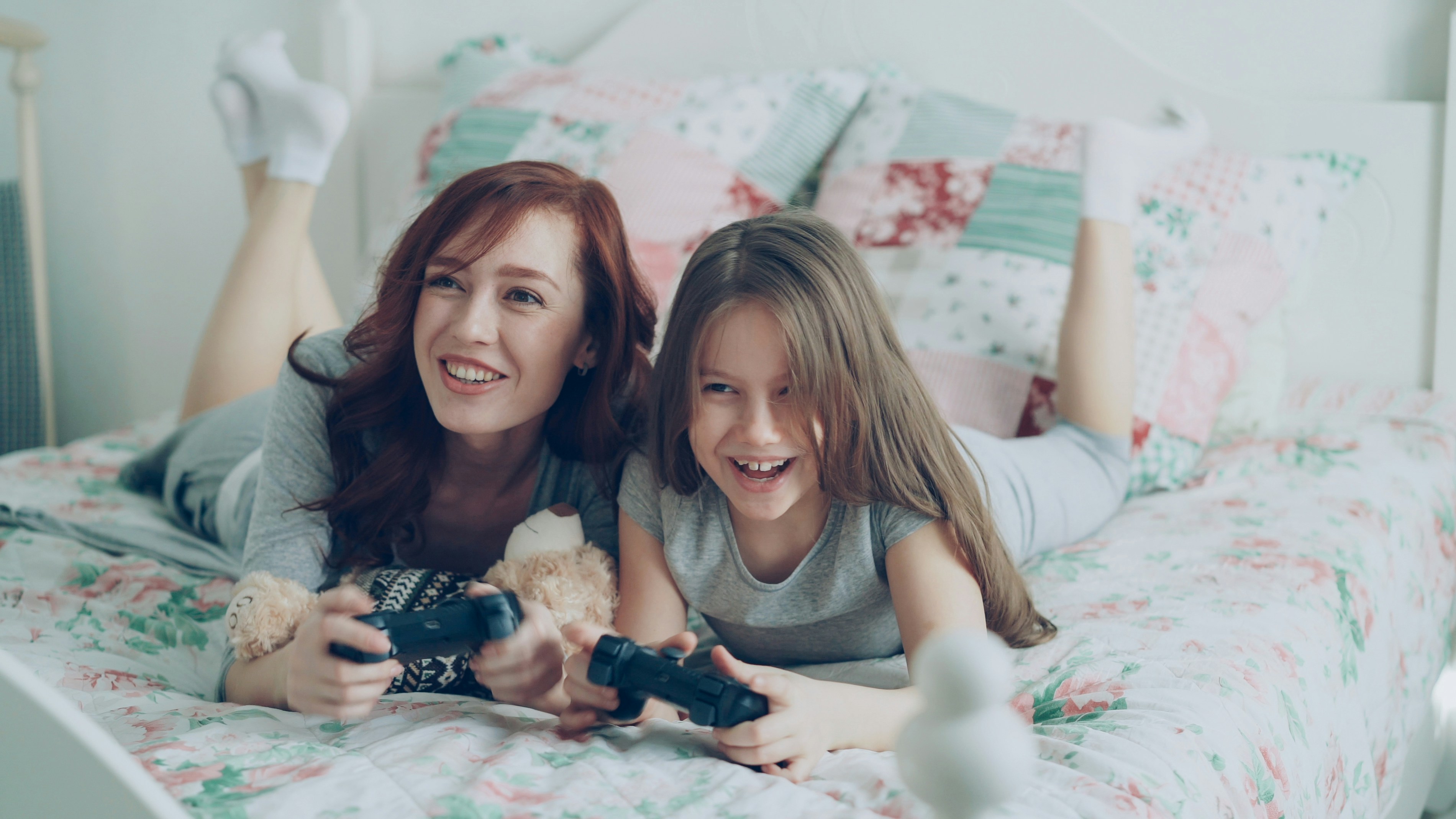 A mother and daughter play video games together