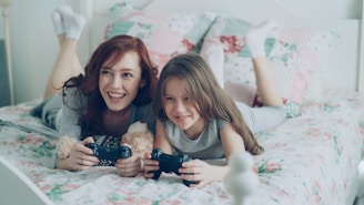 A woman and a child happily play video games.