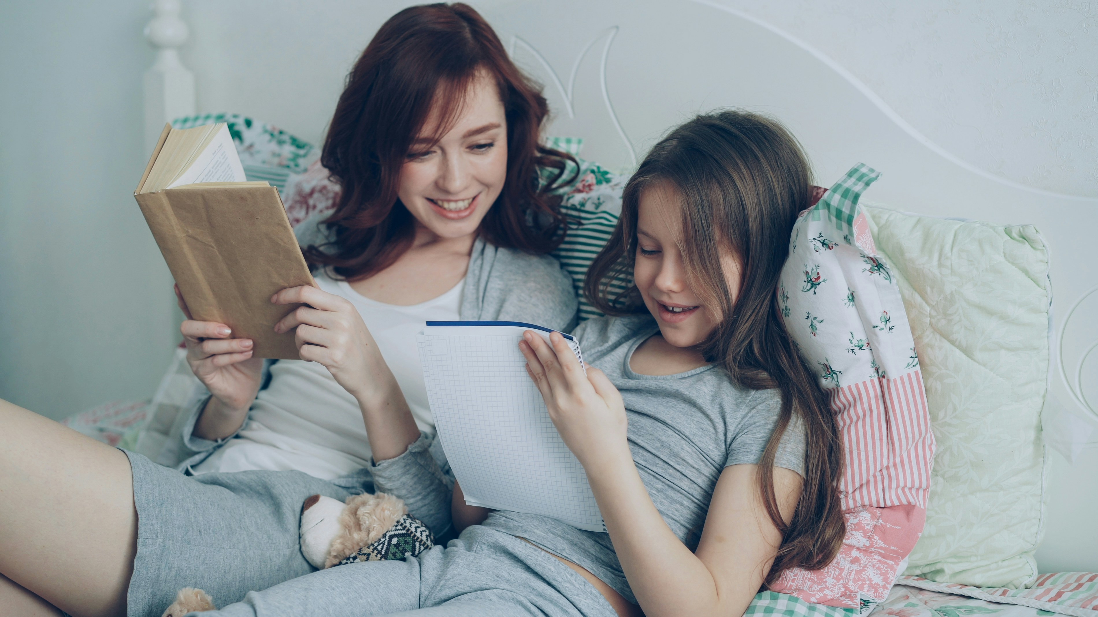 Mother and daughter enjoy reading together.