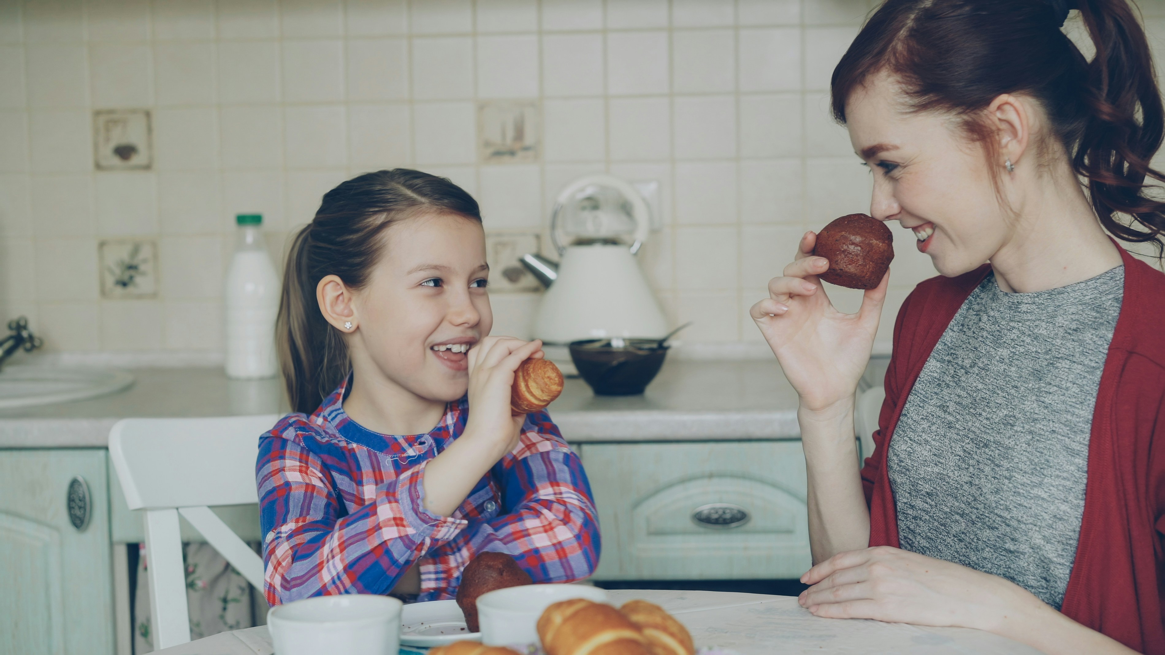 Mother and daughter having breakfast