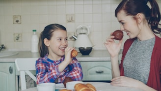 Mother and daughter enjoy breakfast together.