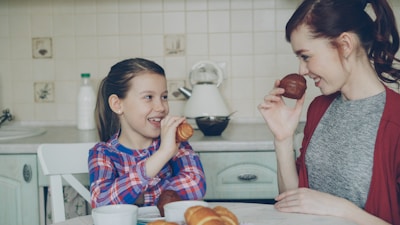 Mother and daughter enjoy breakfast together.