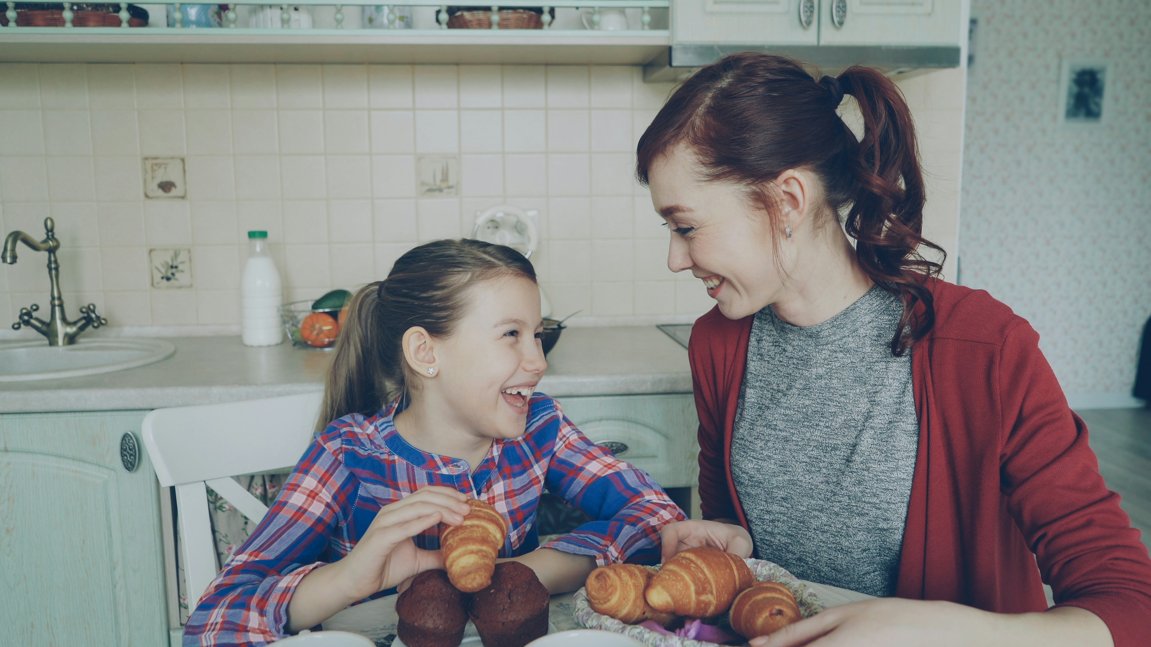 Mother and daughter having breakfast