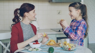 Mother and daughter prepare fruit salad together.