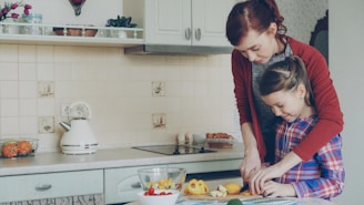 Mother and daughter cook food together in the kitchen.