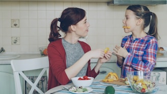 Mother and daughter enjoy snacks in the kitchen.