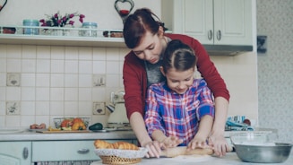 Mother and daughter bake together in the kitchen.