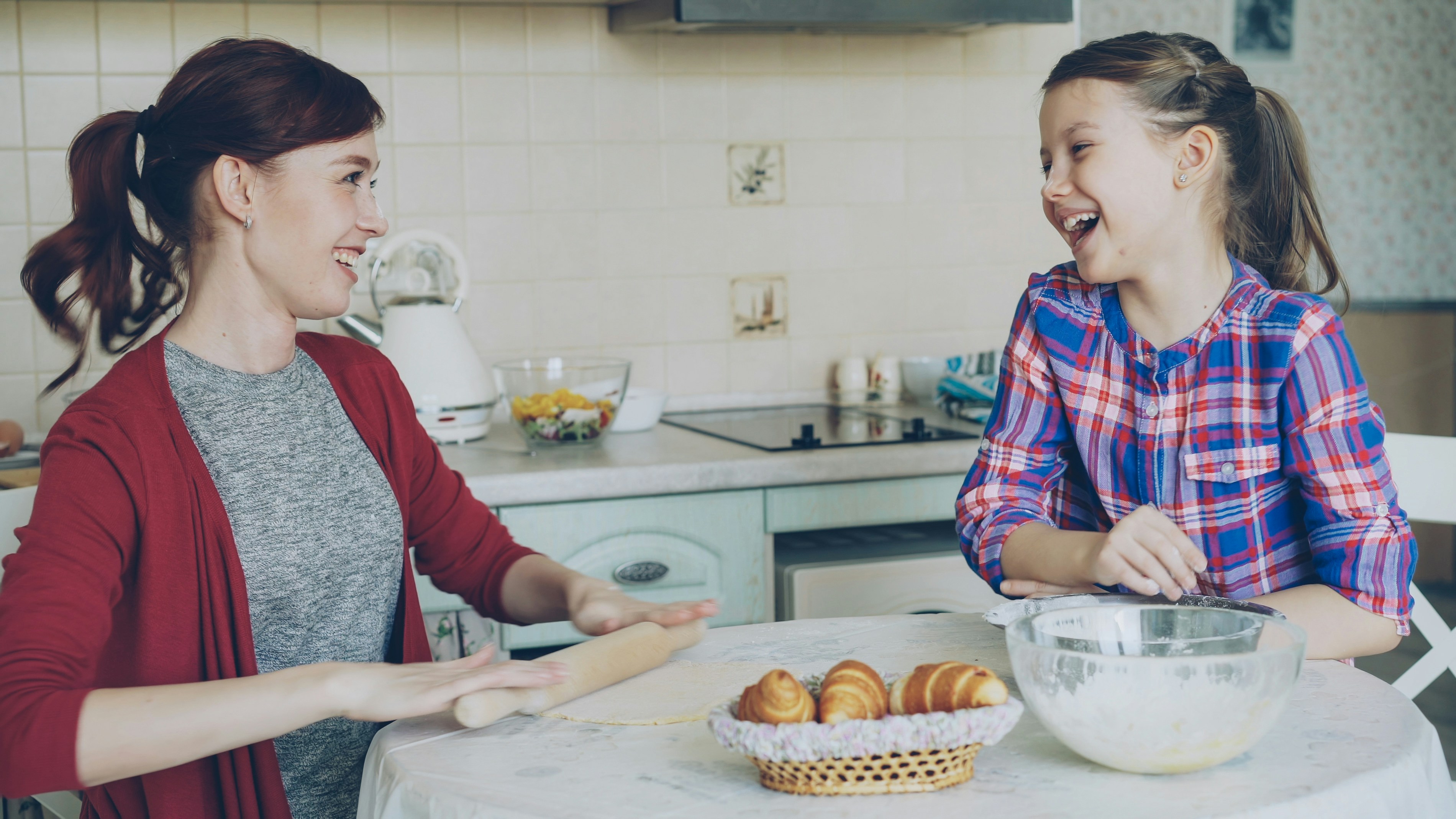 A flat-lay photo of a family kitchen counter featuring fresh vegetables, a tablet running the EasyHome app, and a handwritten grocery list.