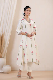 A woman is wearing a floral white outfit.