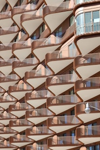 An apartment building has wavy, layered balconies.